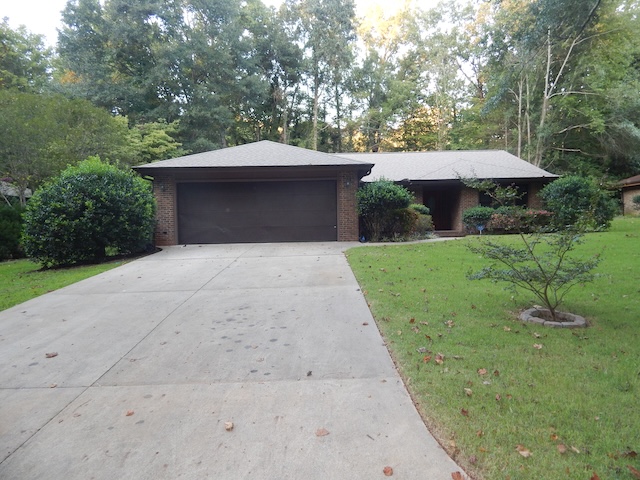620 Downs Loop Clemson, SC 29631 - Photo 1 of 35 Mature trees frame a classic brick exterior with an attached garage and concrete driveway.