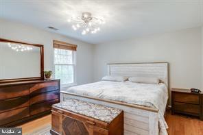 17 Devon Court Sterling, VA 20165 - Photo 19 of 30 a bedroom with a bed and a dresser with wooden floor