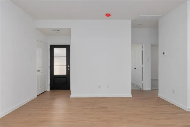 a view of an empty room and closet area