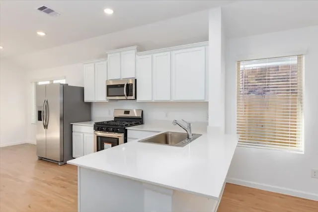 a kitchen with a refrigerator stove and microwave