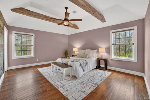 a bedroom with a large bed and a window