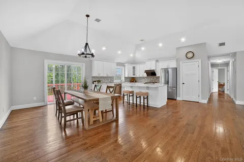 a dining room with furniture and wooden floor