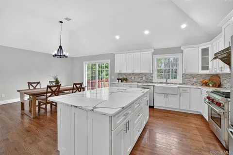 a large white kitchen with lots of counter space