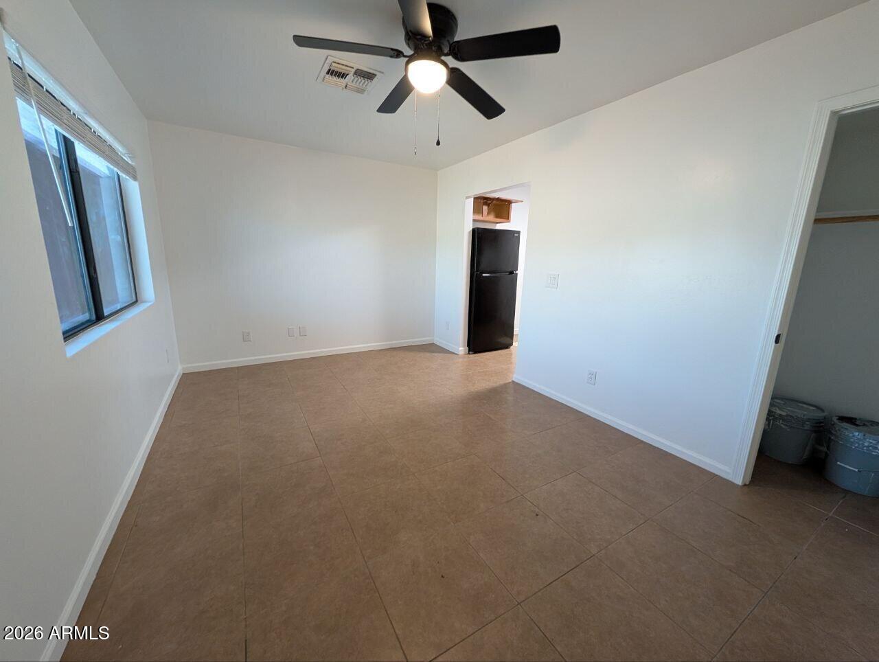 9602 North 18th Avenue Phoenix, AZ 85021 - Photo 10 of 18 a view of empty room with ceiling fan