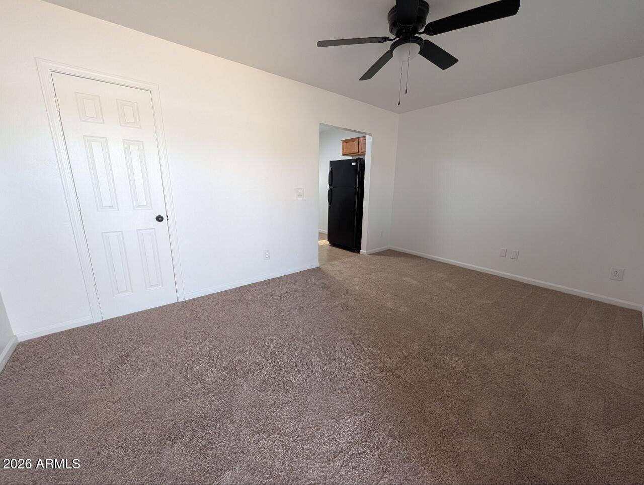 9602 North 18th Avenue Phoenix, AZ 85021 - Photo 11 of 18 a view of an empty room and a ceiling fan