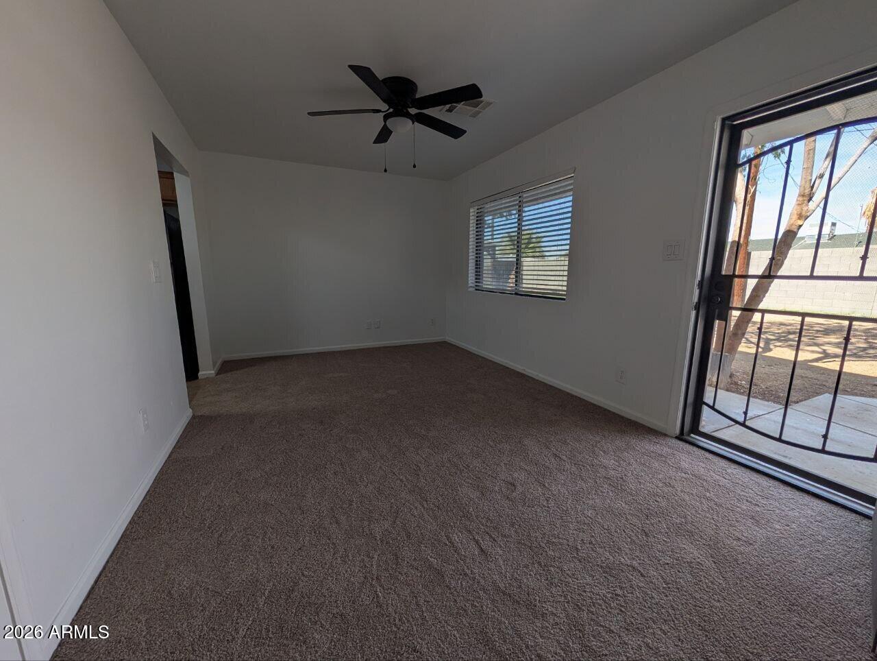 9602 North 18th Avenue Phoenix, AZ 85021 - Photo 2 of 18 an empty room with windows and ceiling fan