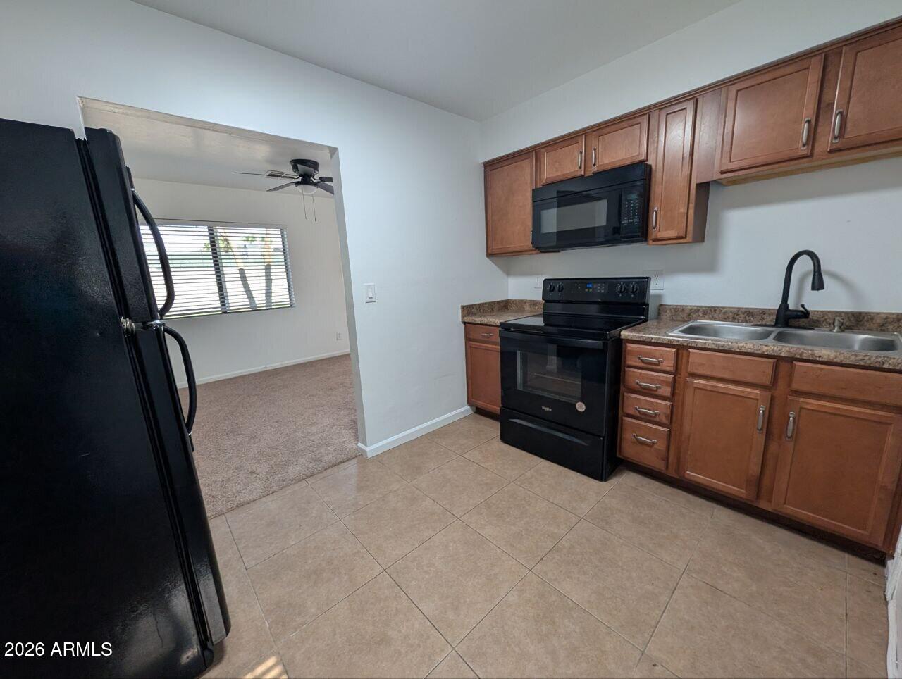 9602 North 18th Avenue Phoenix, AZ 85021 - Photo 3 of 18 a kitchen with stainless steel appliances granite countertop a refrigerator a sink a stove top oven and wooden floor