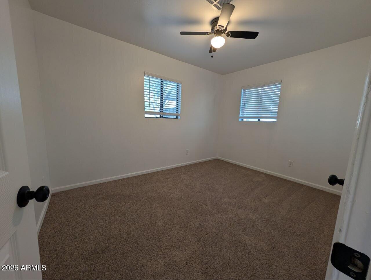 9602 North 18th Avenue Phoenix, AZ 85021 - Photo 4 of 18 a view of a livingroom with a ceiling fan and window
