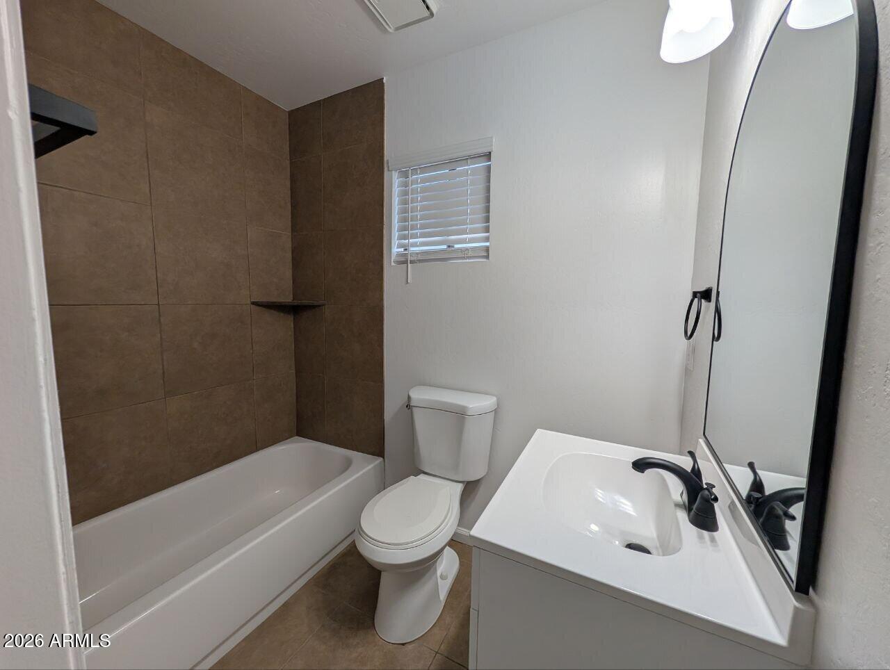 9602 North 18th Avenue Phoenix, AZ 85021 - Photo 5 of 18 a bathroom with a sink a toilet and shower