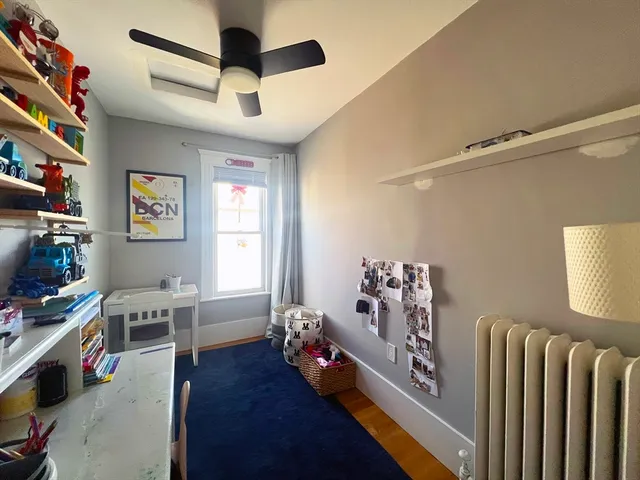 a view of a livingroom with workspace and a window