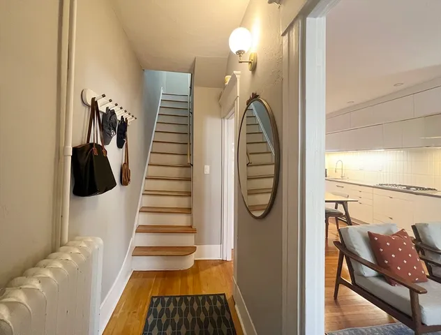 a view of entryway and hall with wooden floor