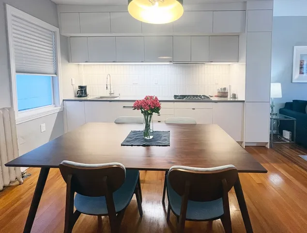 a dining room with furniture and wooden floor