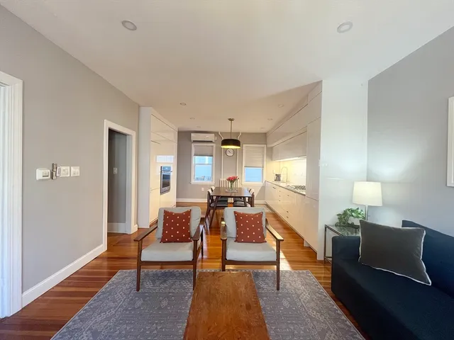 a living room with furniture and a lamp