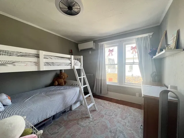 a bedroom with bed and window