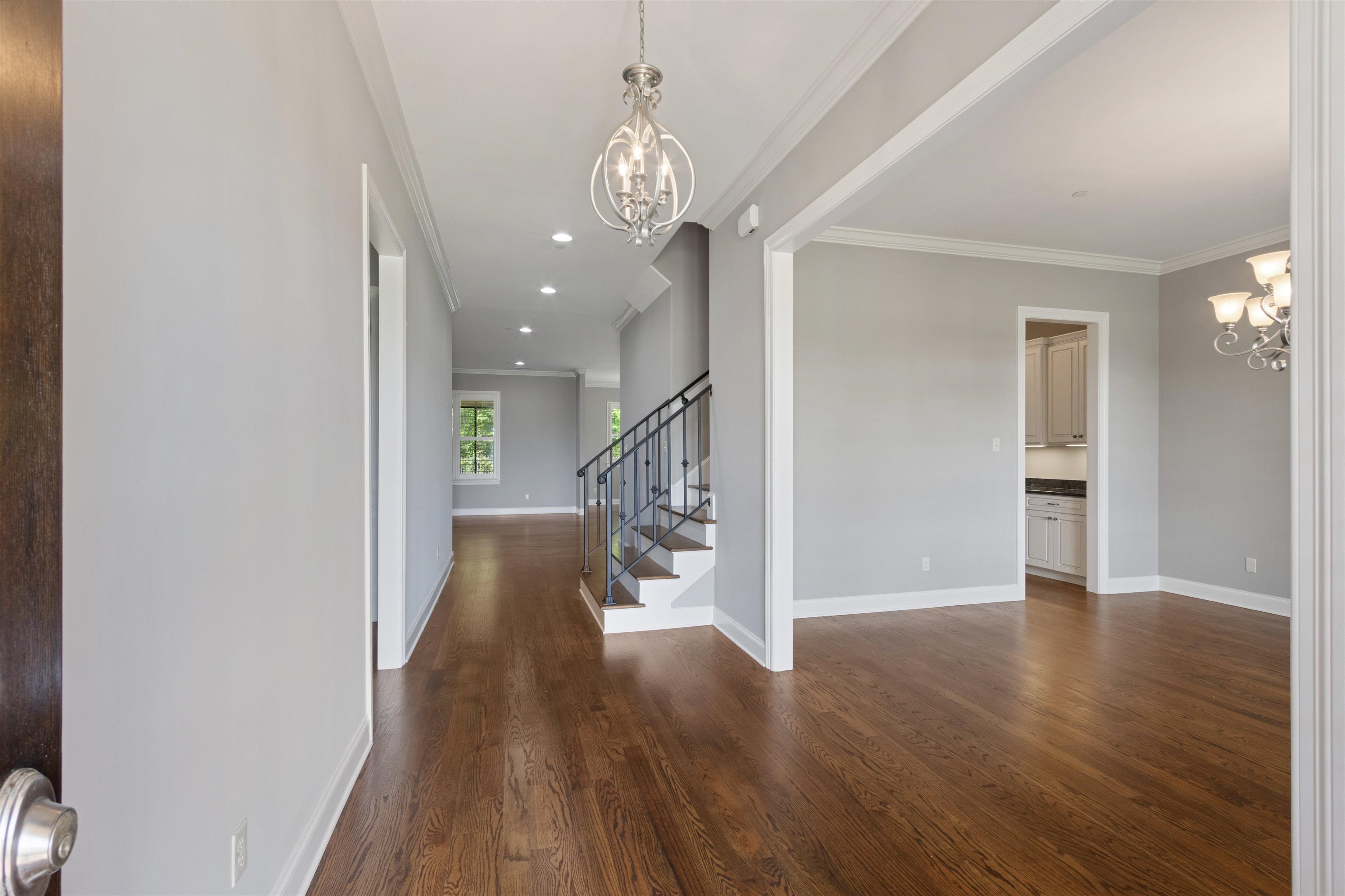 125 Hunters Rest Lane Piperton, TN 38017 - Photo 6 of 38 Entrance foyer featuring a chandelier, ornamental molding, and dark wood-style flooring