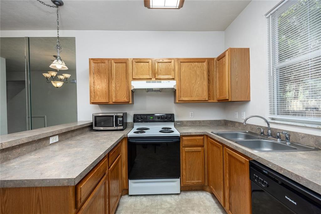 3510 Southwest 30th Way, Unit 158 Gainesville, FL 32608 - Photo 15 of 27 a kitchen with a sink a stove and a window