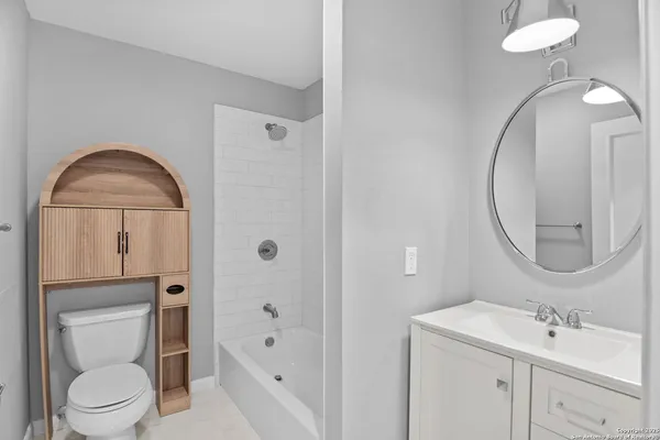 a bathroom with a toilet sink shower and mirror