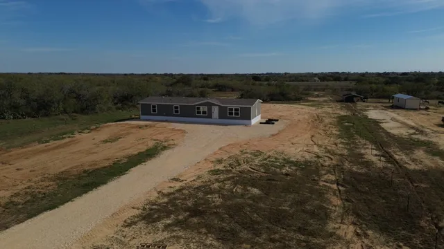 a view of a lake with houses in back