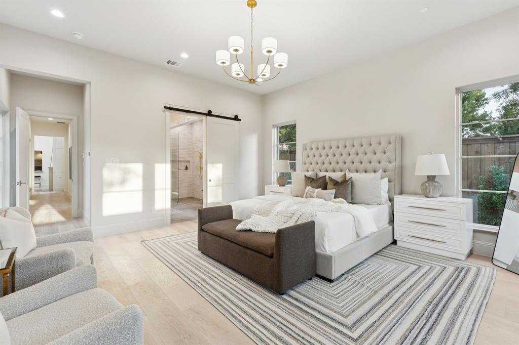 11815 Jamestown Road Dallas, TX 75230 - Photo 14 of 39 a spacious bedroom with a large bed and a chandelier