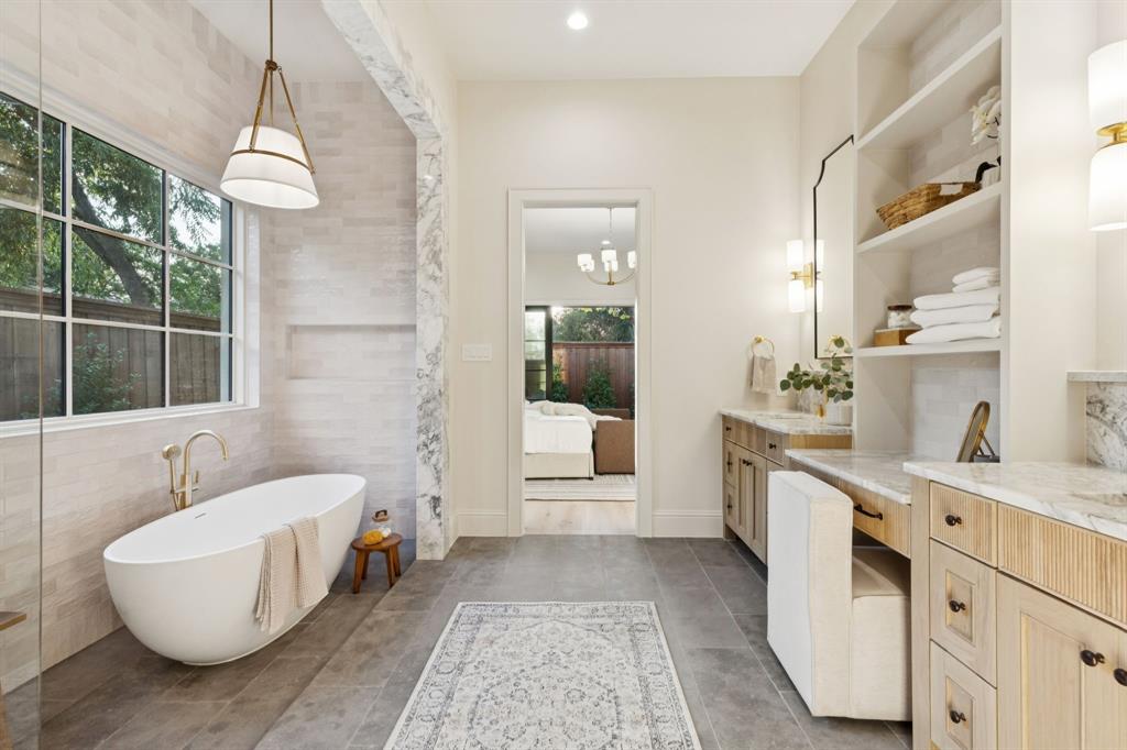 11815 Jamestown Road Dallas, TX 75230 - Photo 15 of 39 a bathroom with a double vanity sink a mirror and a bathtub