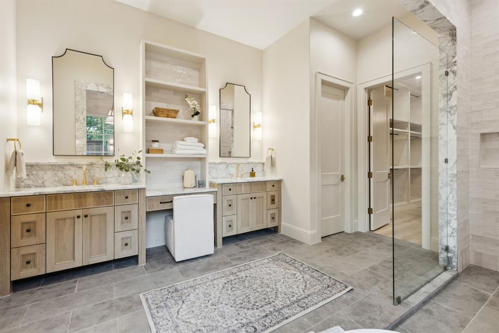 11815 Jamestown Road Dallas, TX 75230 - Photo 16 of 39 a spacious bathroom with a shower sink and mirror