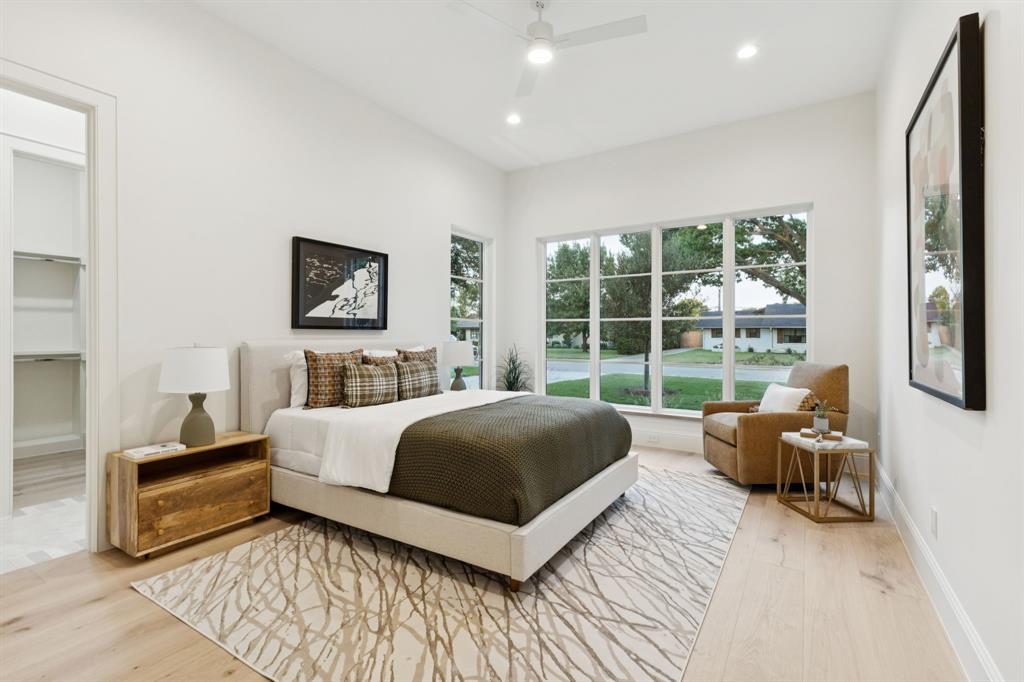 11815 Jamestown Road Dallas, TX 75230 - Photo 18 of 39 a bedroom with a bed couch and large window
