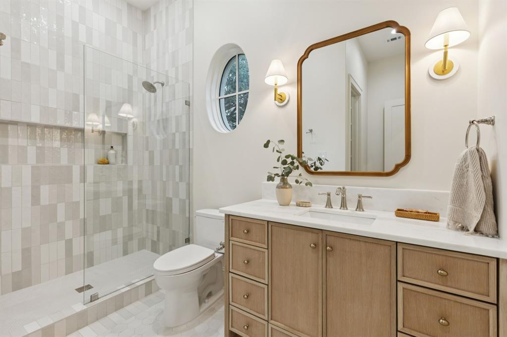 11815 Jamestown Road Dallas, TX 75230 - Photo 19 of 39 a bathroom with a toilet sink and shower