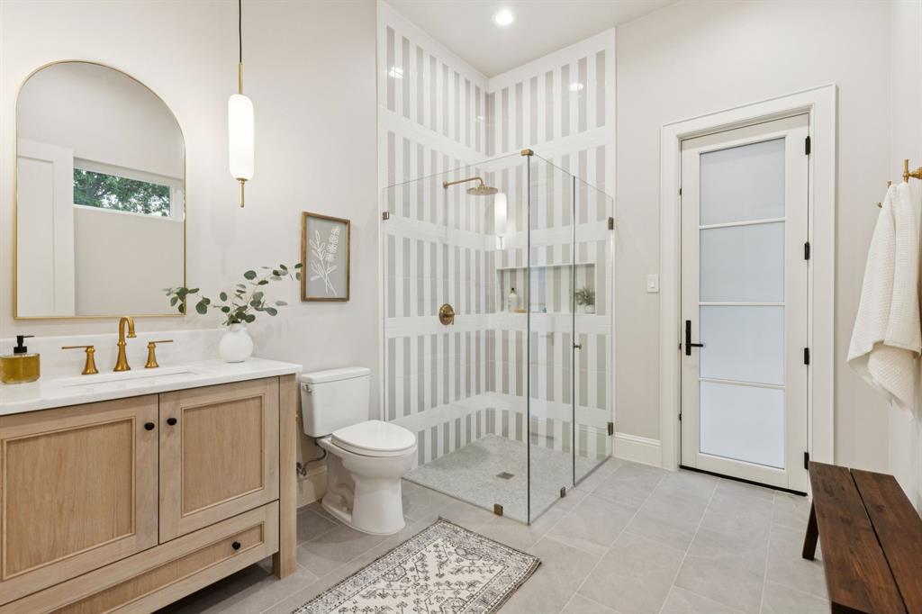 11815 Jamestown Road Dallas, TX 75230 - Photo 22 of 39 a bathroom with a sink a toilet and shower