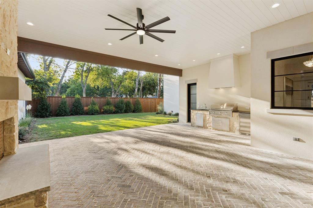 11815 Jamestown Road Dallas, TX 75230 - Photo 31 of 39 a view of a porch with a floor to ceiling window and a yard