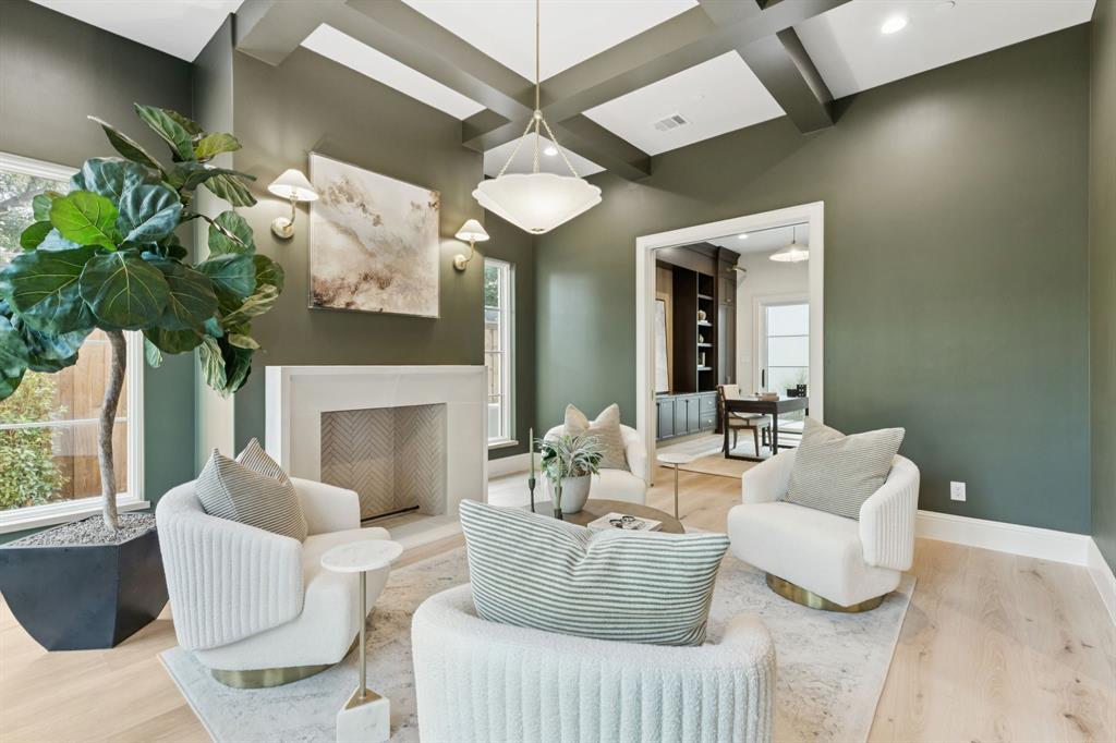 11815 Jamestown Road Dallas, TX 75230 - Photo 37 of 39 a living room with furniture a fireplace and a chandelier