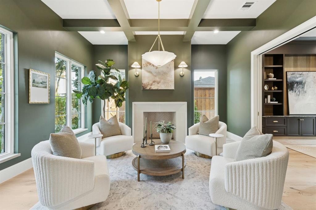 11815 Jamestown Road Dallas, TX 75230 - Photo 6 of 39 a living room with furniture a fireplace and a chandelier