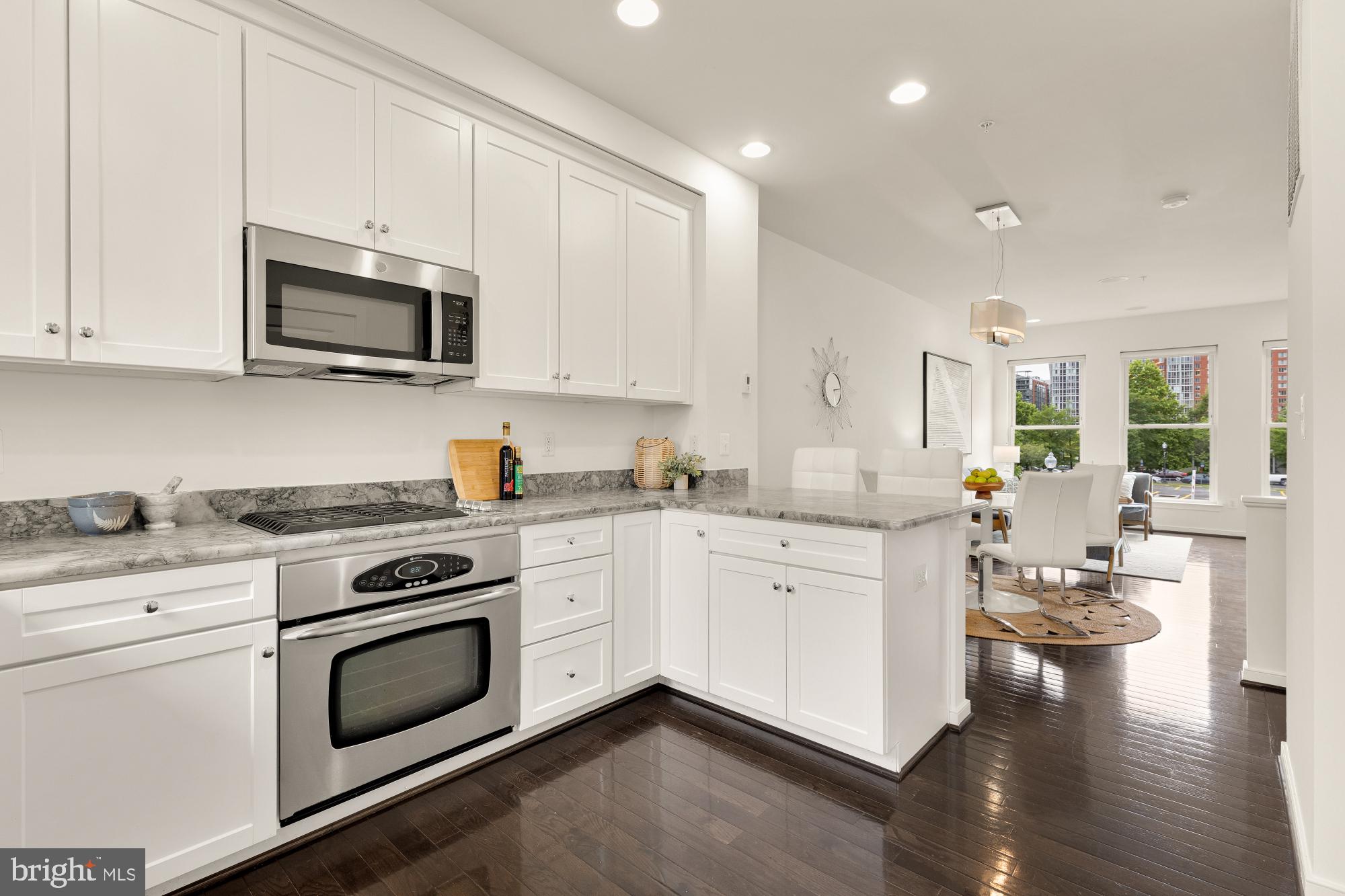 906 3rd Street Southeast Washington, DC 20003 - Photo 5 of 14 a kitchen with a stove white cabinets and white appliances