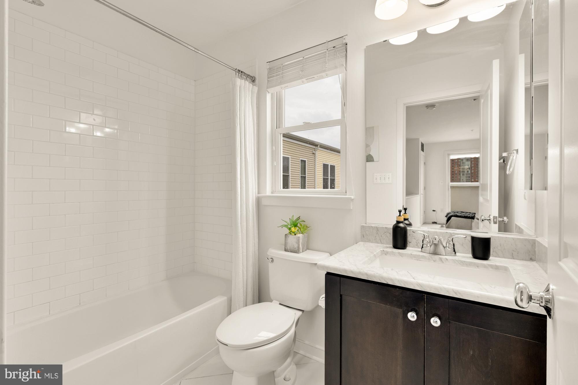 906 3rd Street Southeast Washington, DC 20003 - Photo 7 of 14 a bathroom with a granite countertop sink toilet and shower