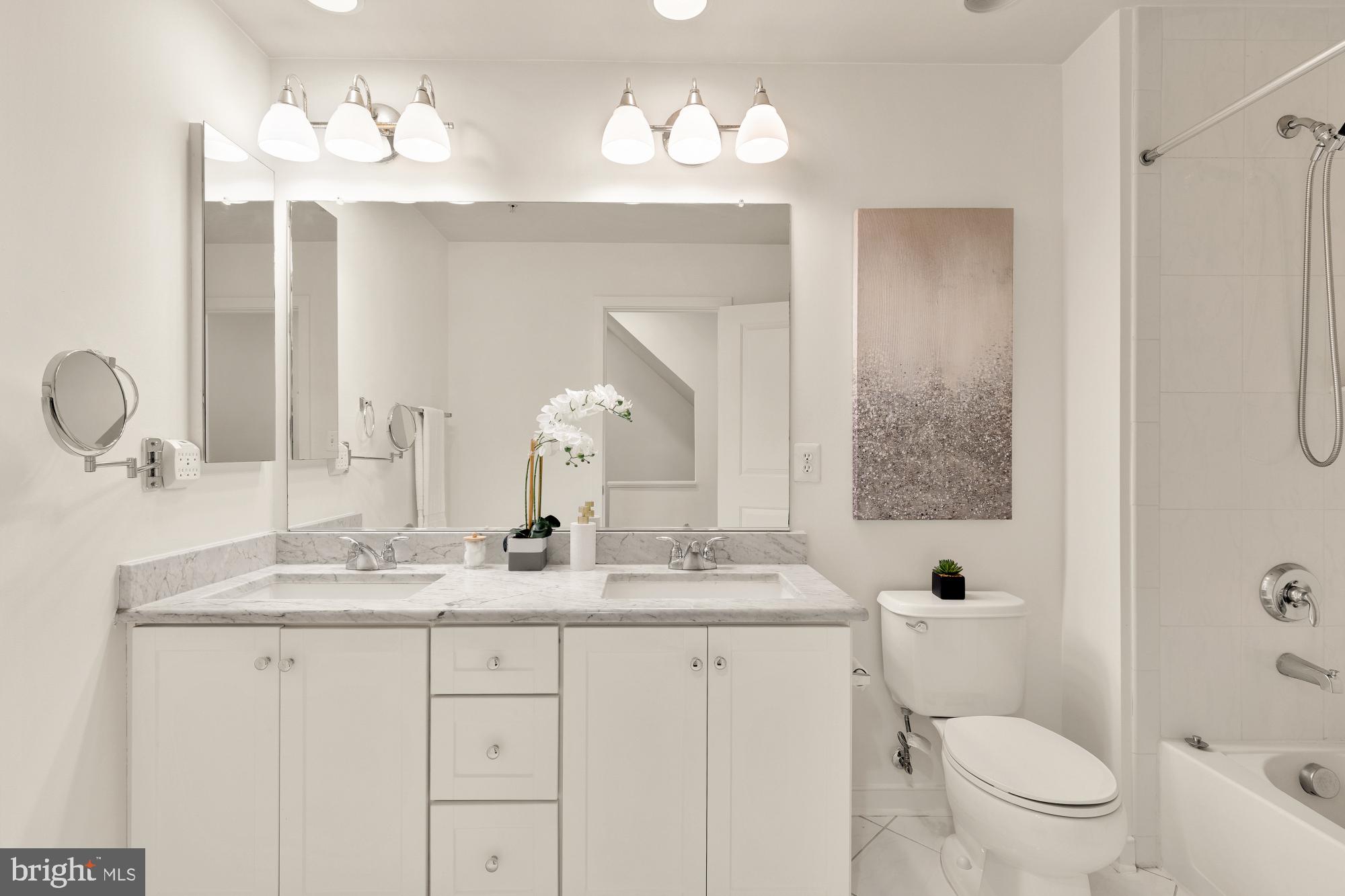 906 3rd Street Southeast Washington, DC 20003 - Photo 10 of 14 a bathroom with a granite countertop sink mirror and toilet
