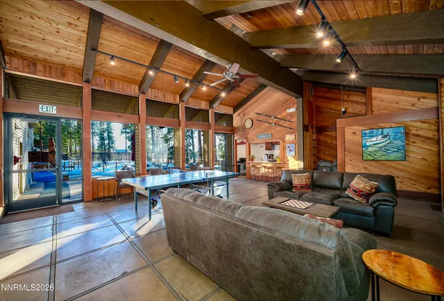 a living room with furniture a rug and a large window