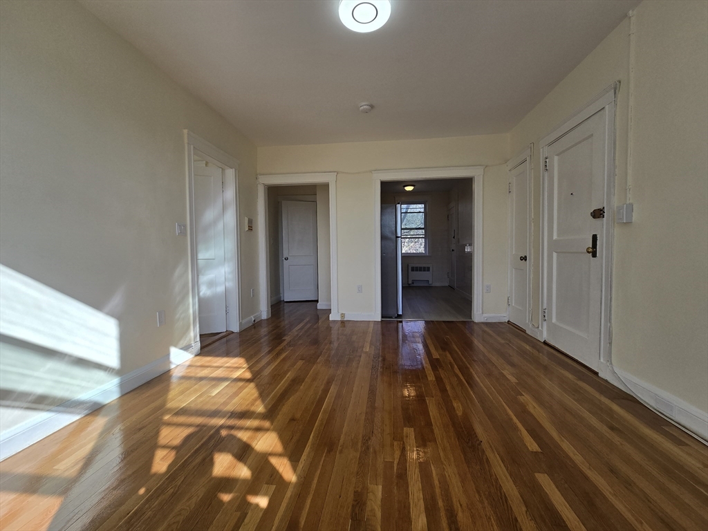 183 Kent Street, Unit 5 Brookline, MA 02446 - Photo 3 of 9 a view of wooden floor in an empty room