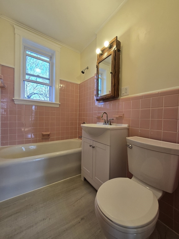 183 Kent Street, Unit 5 Brookline, MA 02446 - Photo 9 of 9 a bathroom with a toilet a sink and mirror