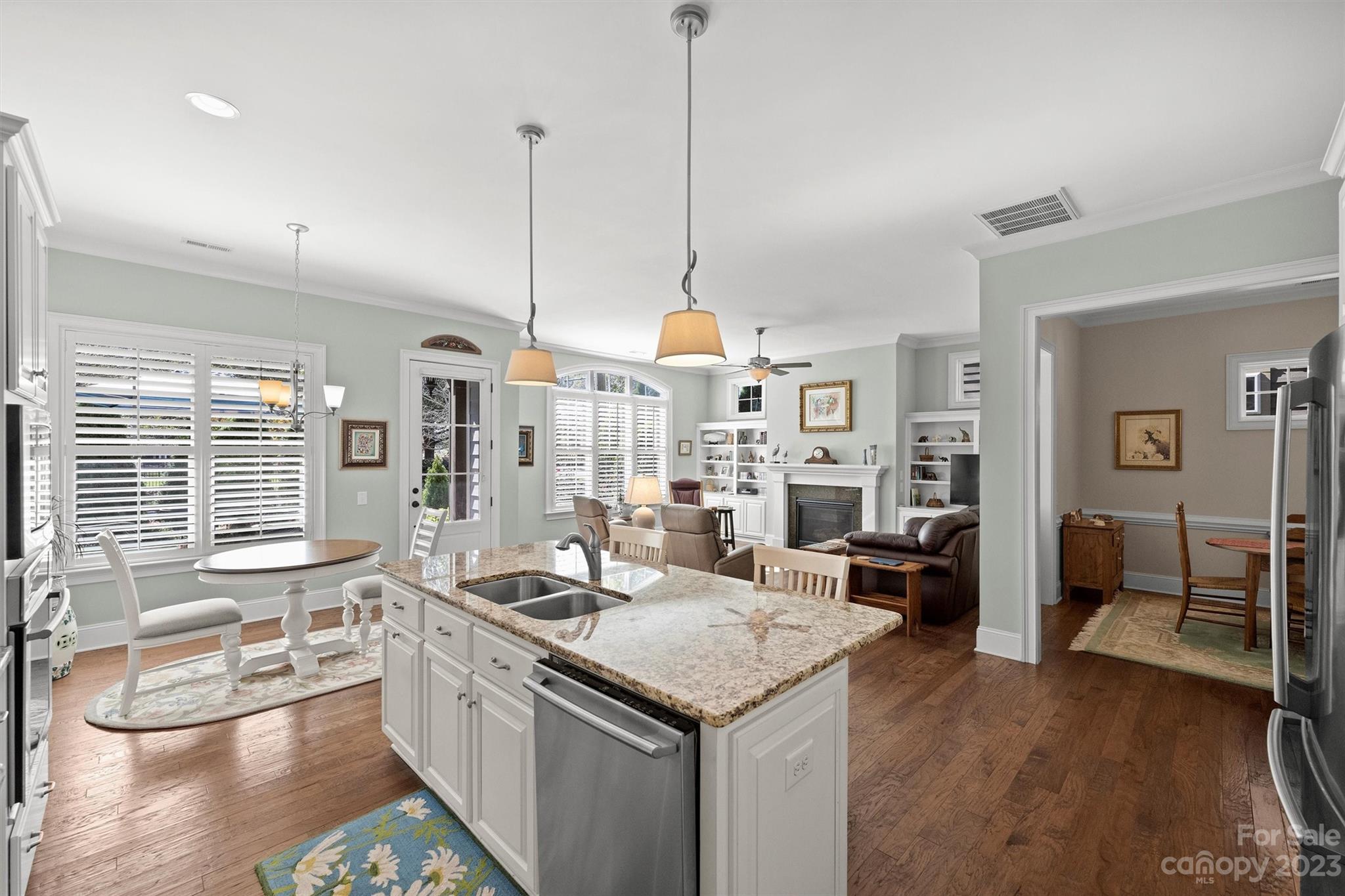 111 Boyce Road Charlotte, NC 28211 - Photo 12 of 38 a kitchen with stainless steel appliances granite countertop a sink stove and wooden floor