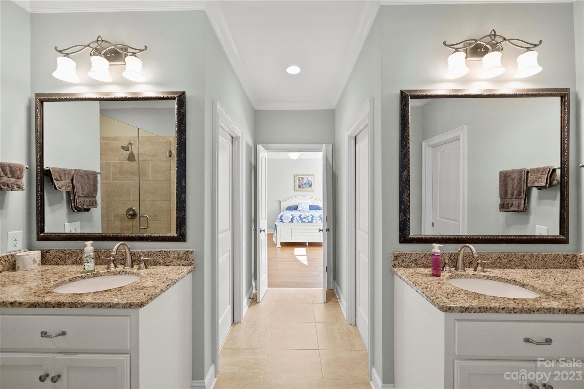 111 Boyce Road Charlotte, NC 28211 - Photo 28 of 38 a en suite bathroom with a granite countertop sink and a mirror