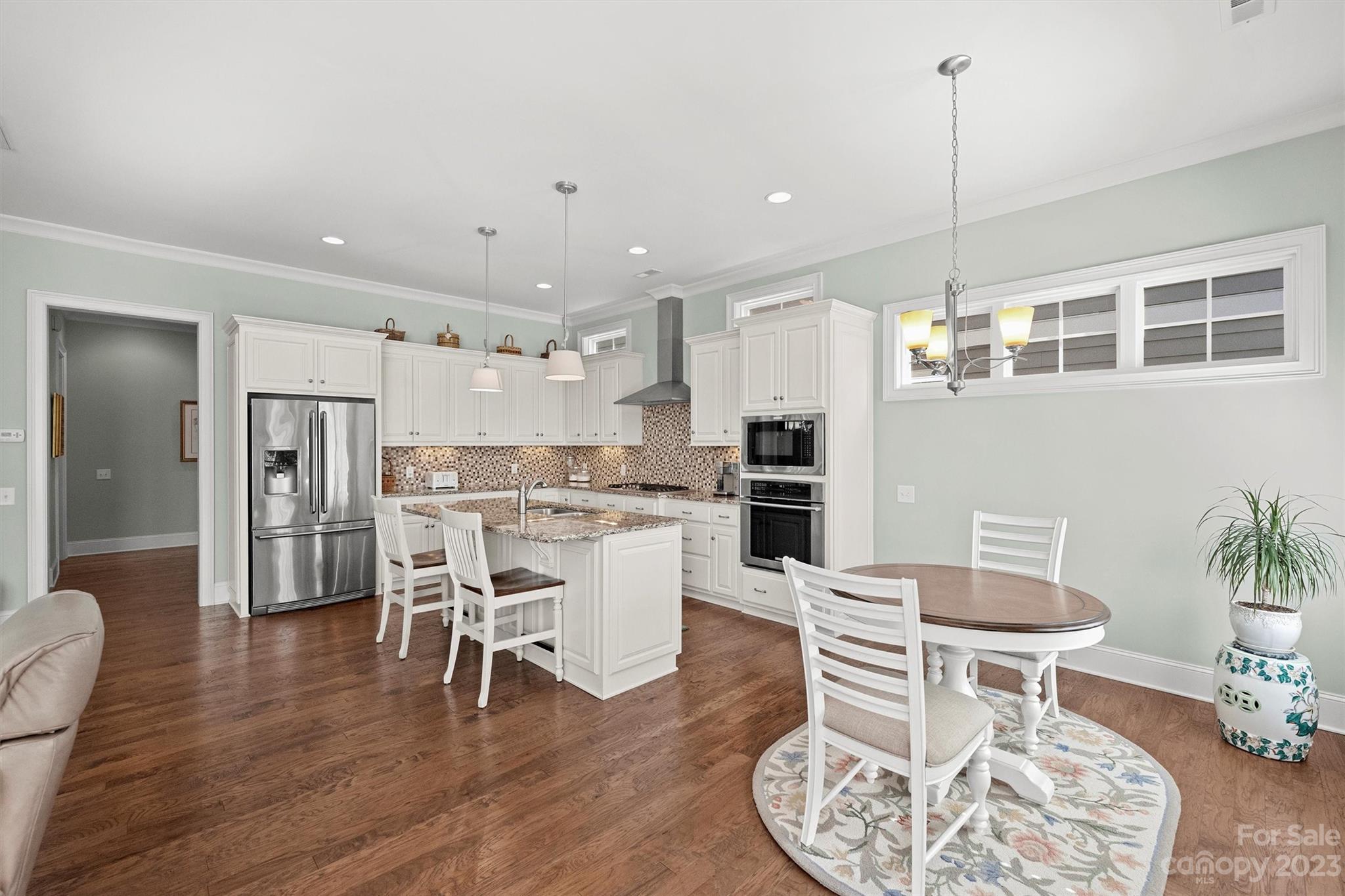 111 Boyce Road Charlotte, NC 28211 - Photo 9 of 38 a dining room with furniture and wooden floor