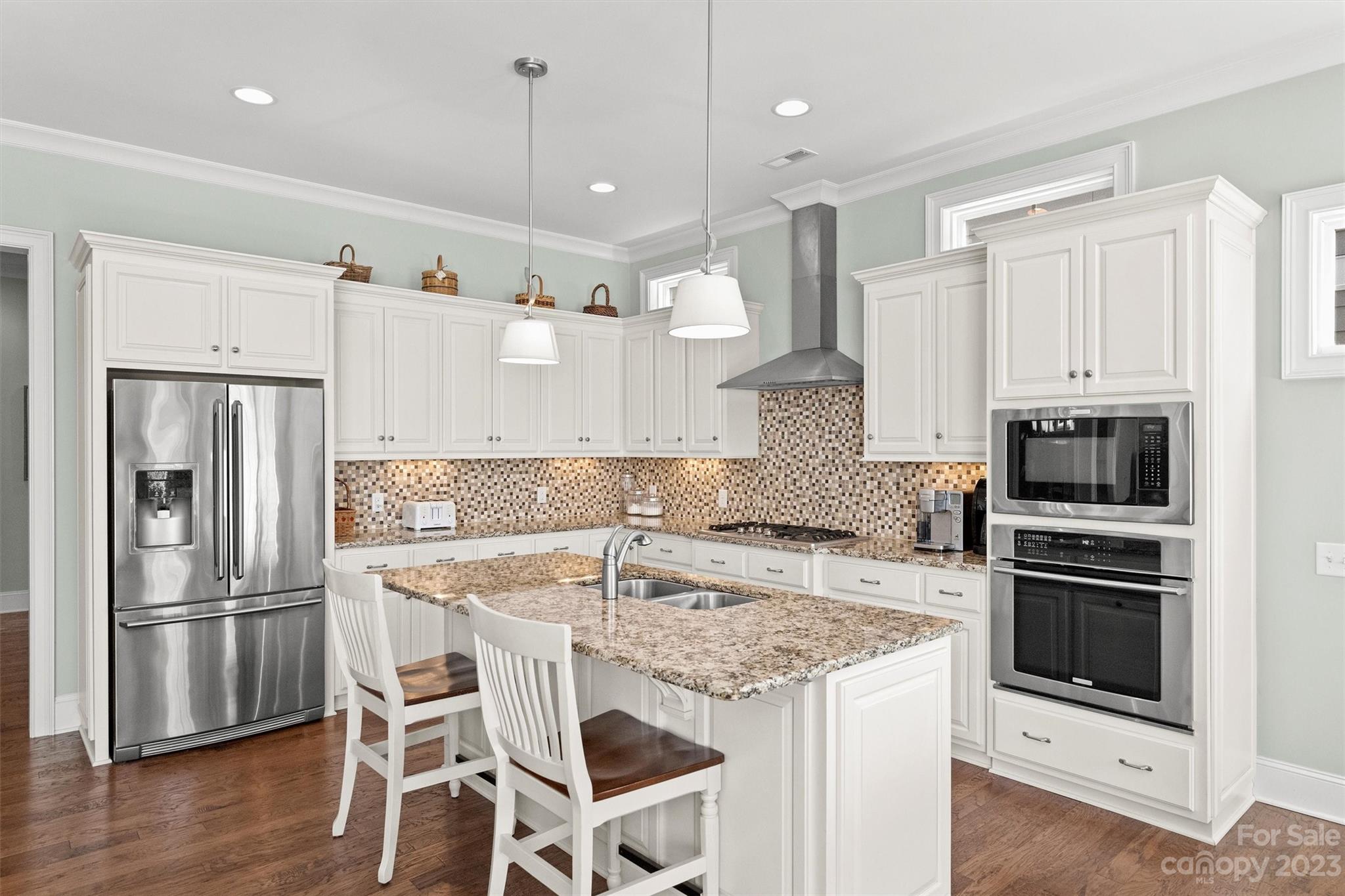 111 Boyce Road Charlotte, NC 28211 - Photo 10 of 38 a kitchen with stainless steel appliances granite countertop a kitchen island hardwood floor and a sink