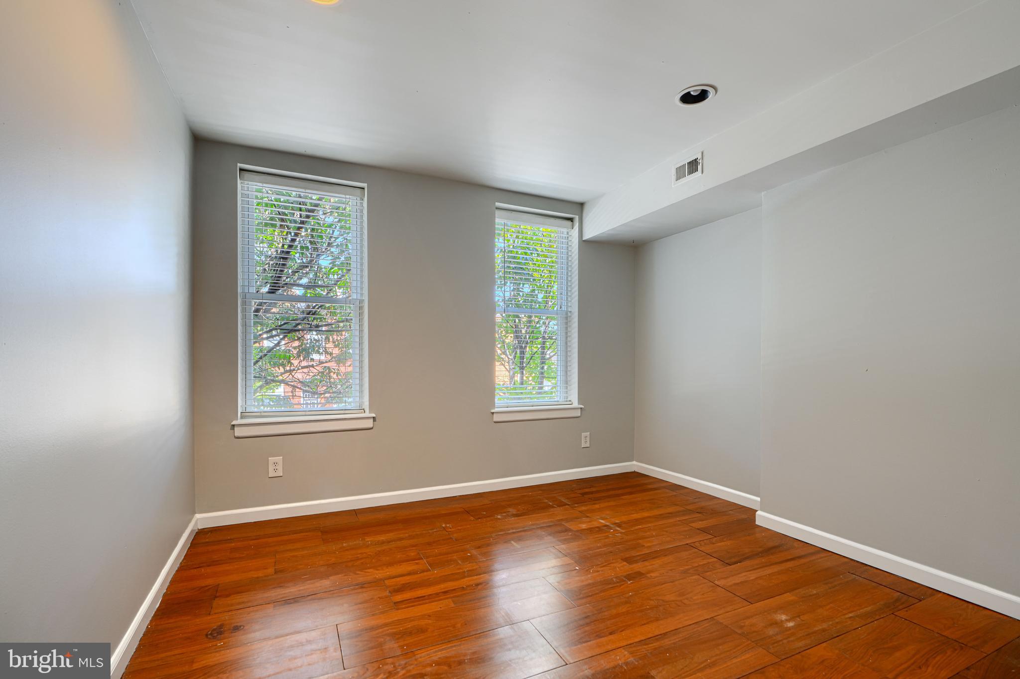 2519 Fleet Street Baltimore, MD 21224 - Photo 13 of 31 an empty room with wooden floor and windows
