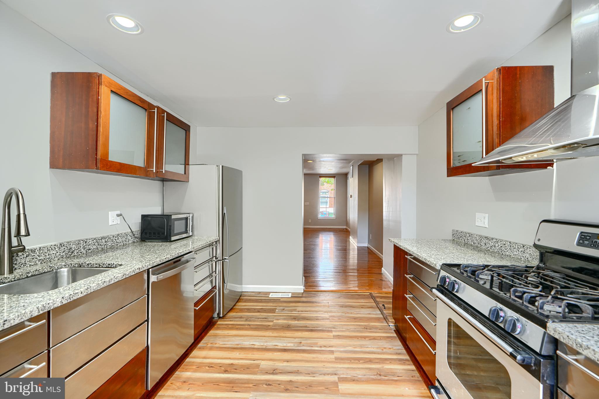 2519 Fleet Street Baltimore, MD 21224 - Photo 8 of 31 a kitchen with stainless steel appliances granite countertop a stove and a sink