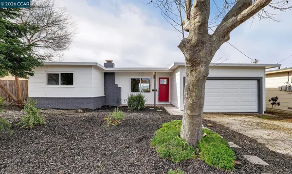 a front view of house with yard and trees