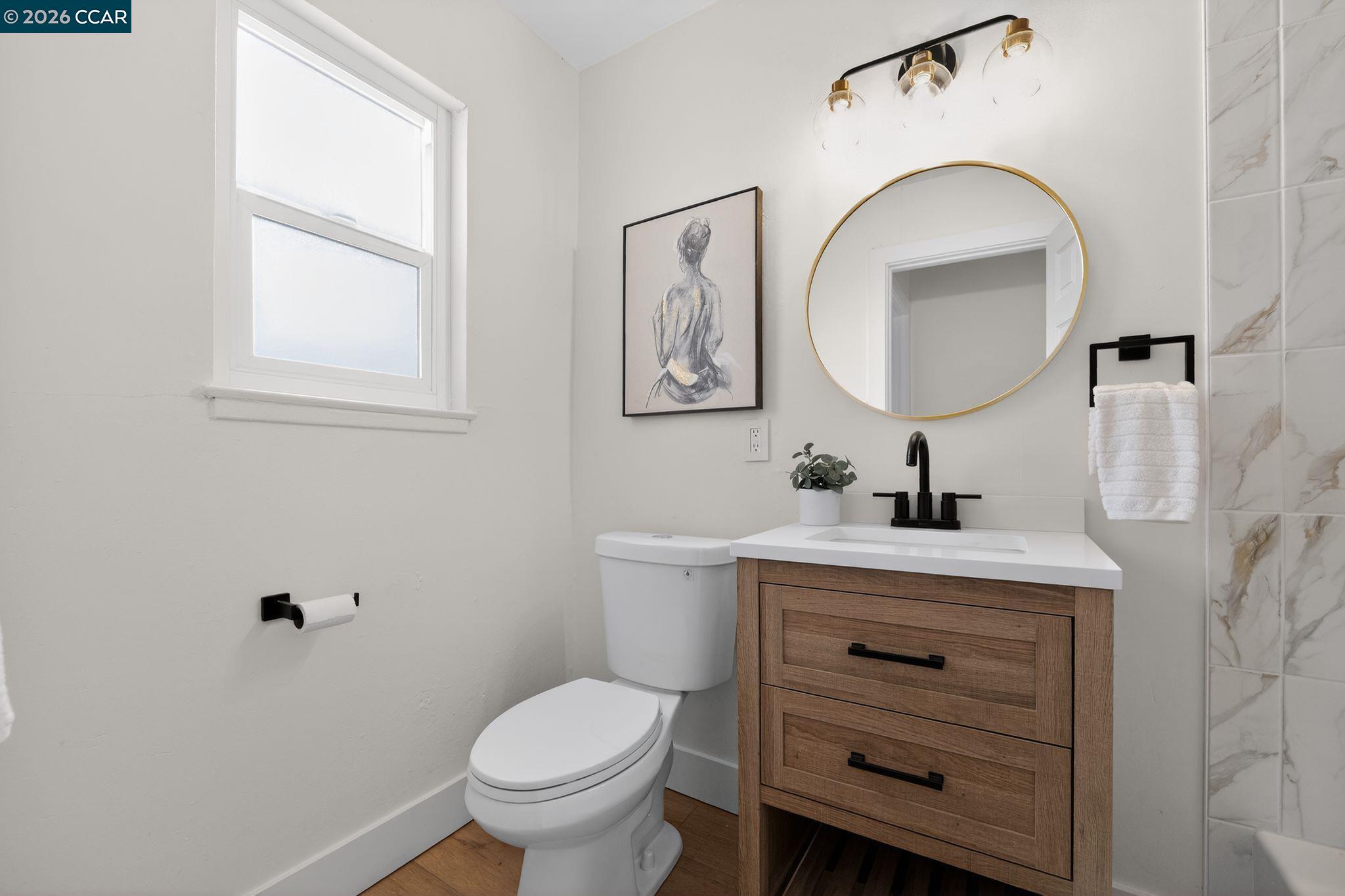 1838 Overhill Road Concord, CA 94520 - Photo 15 of 25 a bathroom with a toilet sink vanity and mirror