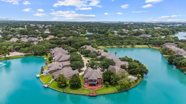 an aerial view of a house with a lake view