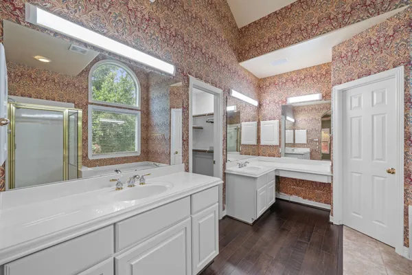 a bathroom with a double vanity sink and a large mirror
