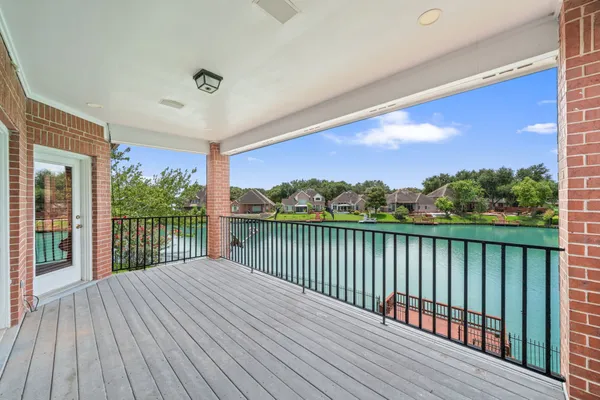 a balcony with wooden floor and fence