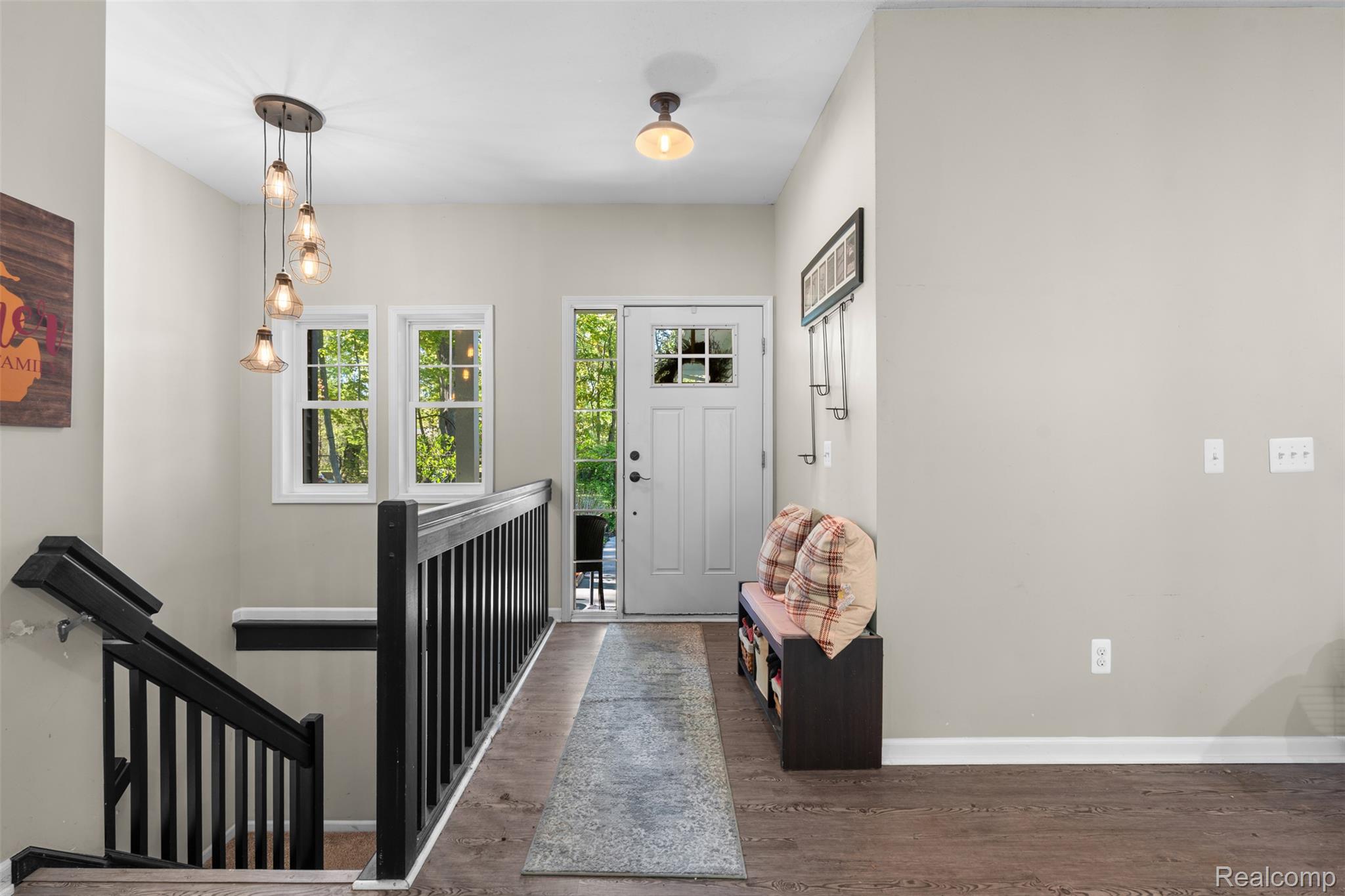 Foyer entrance featuring baseboards and wood finished floors