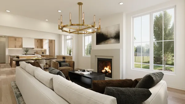 a living room with furniture a chandelier and a fireplace